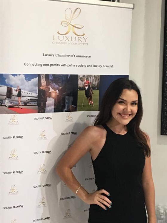 Celine Alva in front of Luxury Chamber Step and Repeat or Tradeshow Banner June 2020